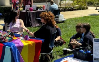 Pride Org representatives gather at a table at the Student Org Fair 2024