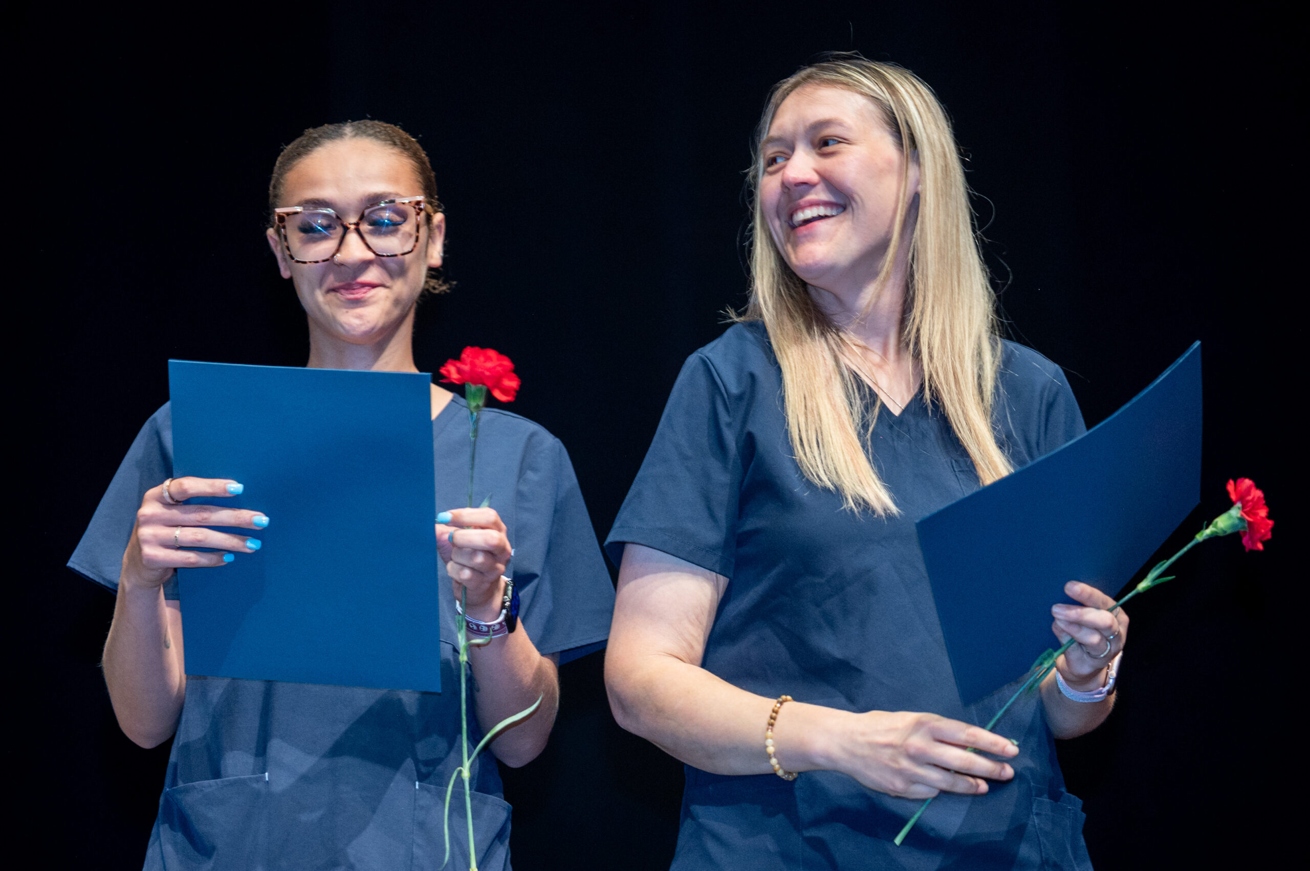 HCG_6-30-26_24 Dental Assistant graduates receive certificates and flowers during a graduation ceremony