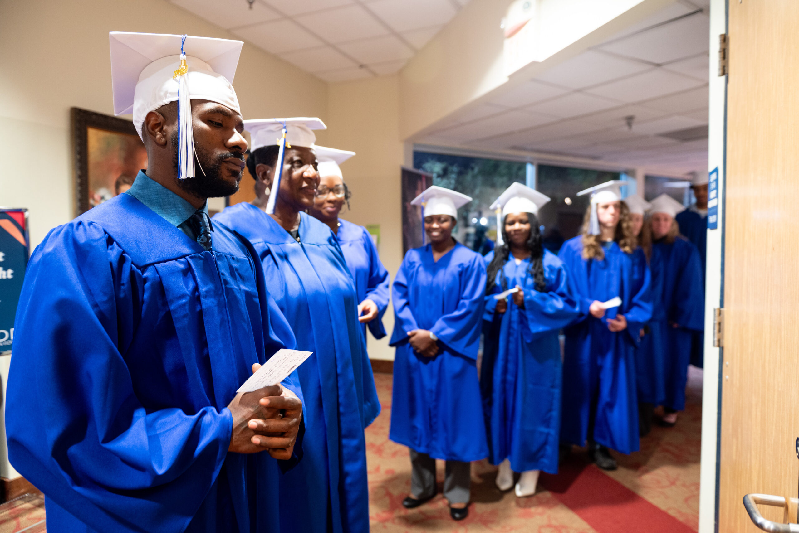 AEG_10-15-24_29 Adult Basic Ed graduates pose in caps and gowns, October 2024