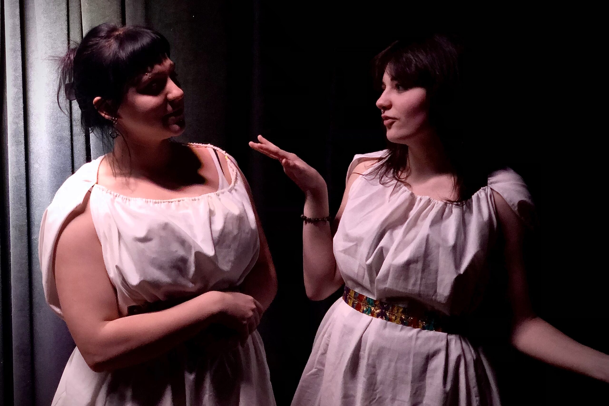two actors in costumes play their parts side by side