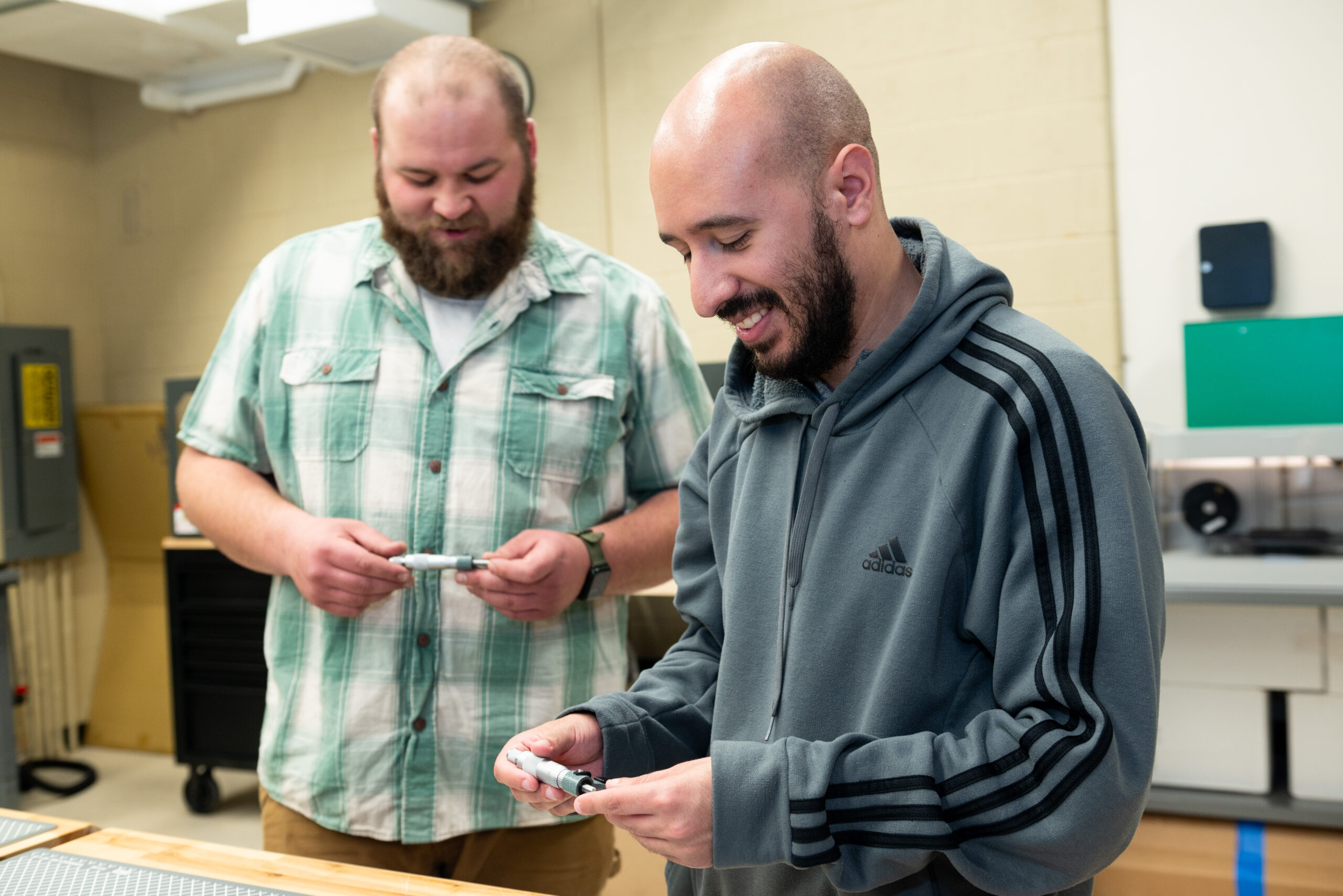 an instructor lectures before students in a classroom