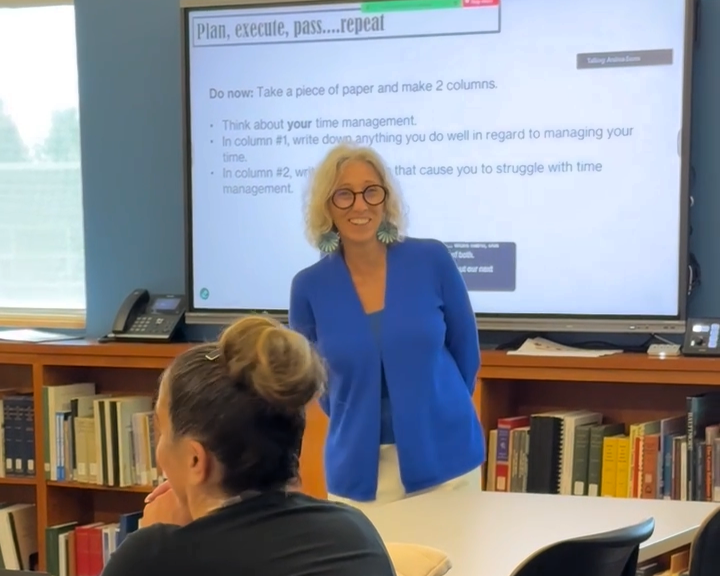 Andrea Evans smiles as she talks with a student during a workshop