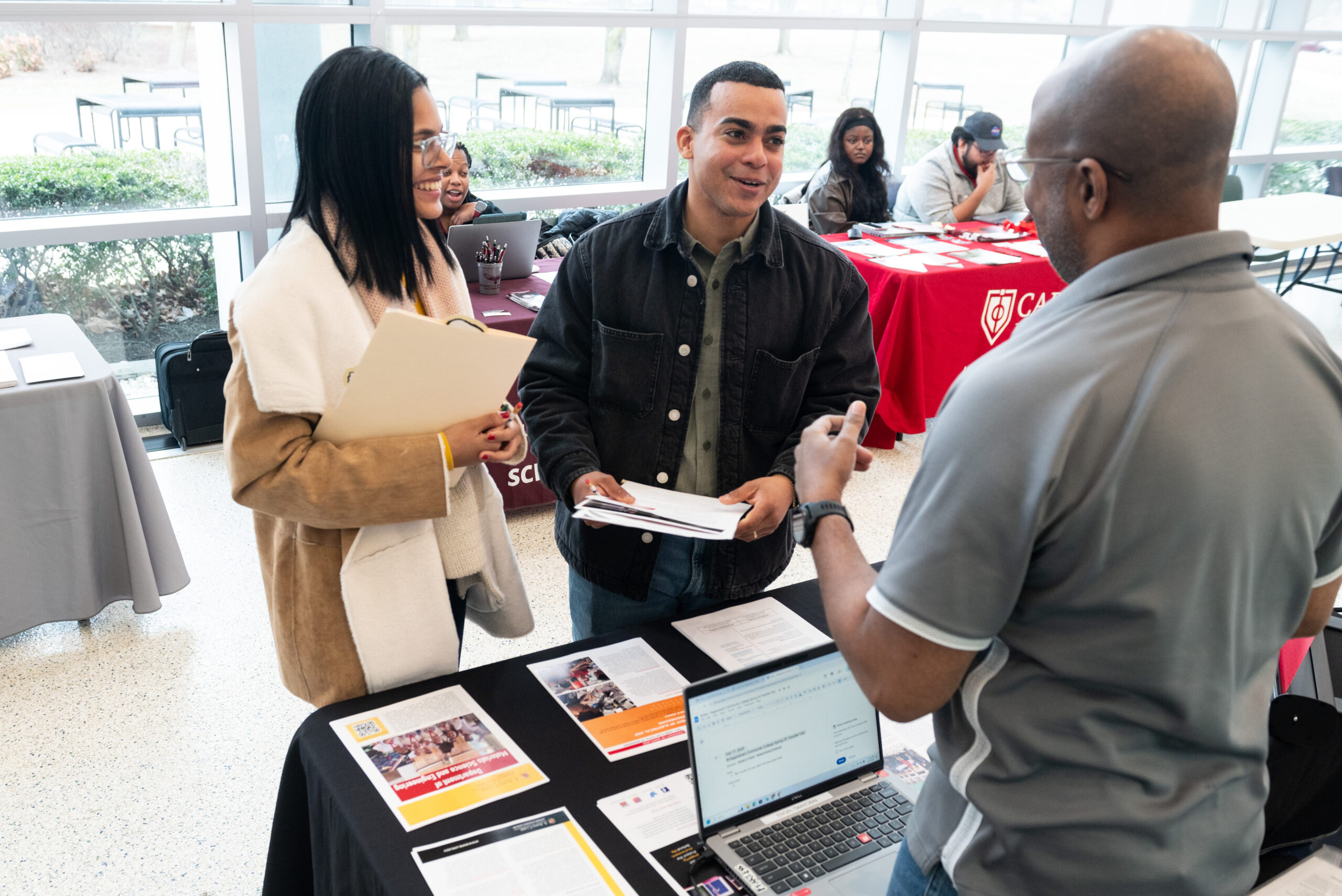 students explore transfer options with four-year school representatives during Transfer Day