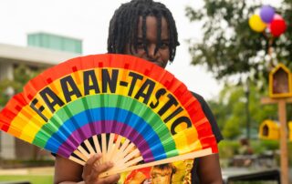 Faaan-tastic rainbow fan and student