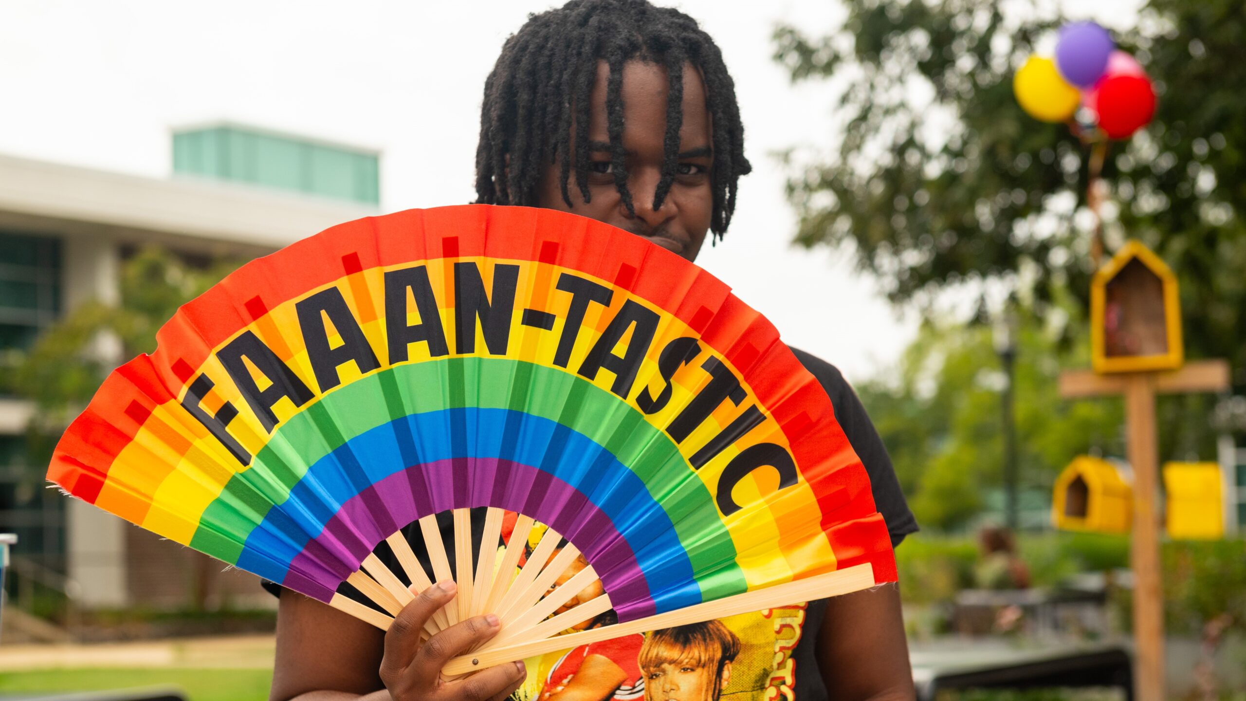 Faaan-tastic rainbow fan and student