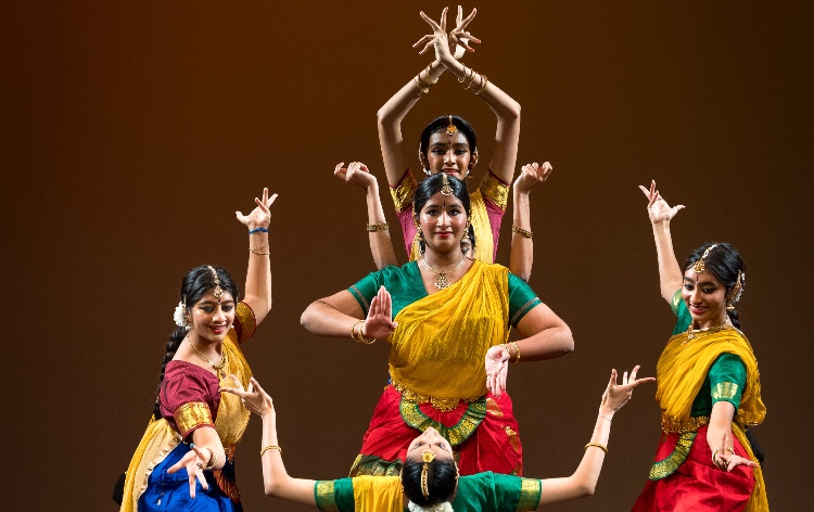 five dancers in Far East dress in a choreographed dance