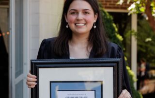 Harrison Award winner Zoe Markovic shown here holding the framed award.