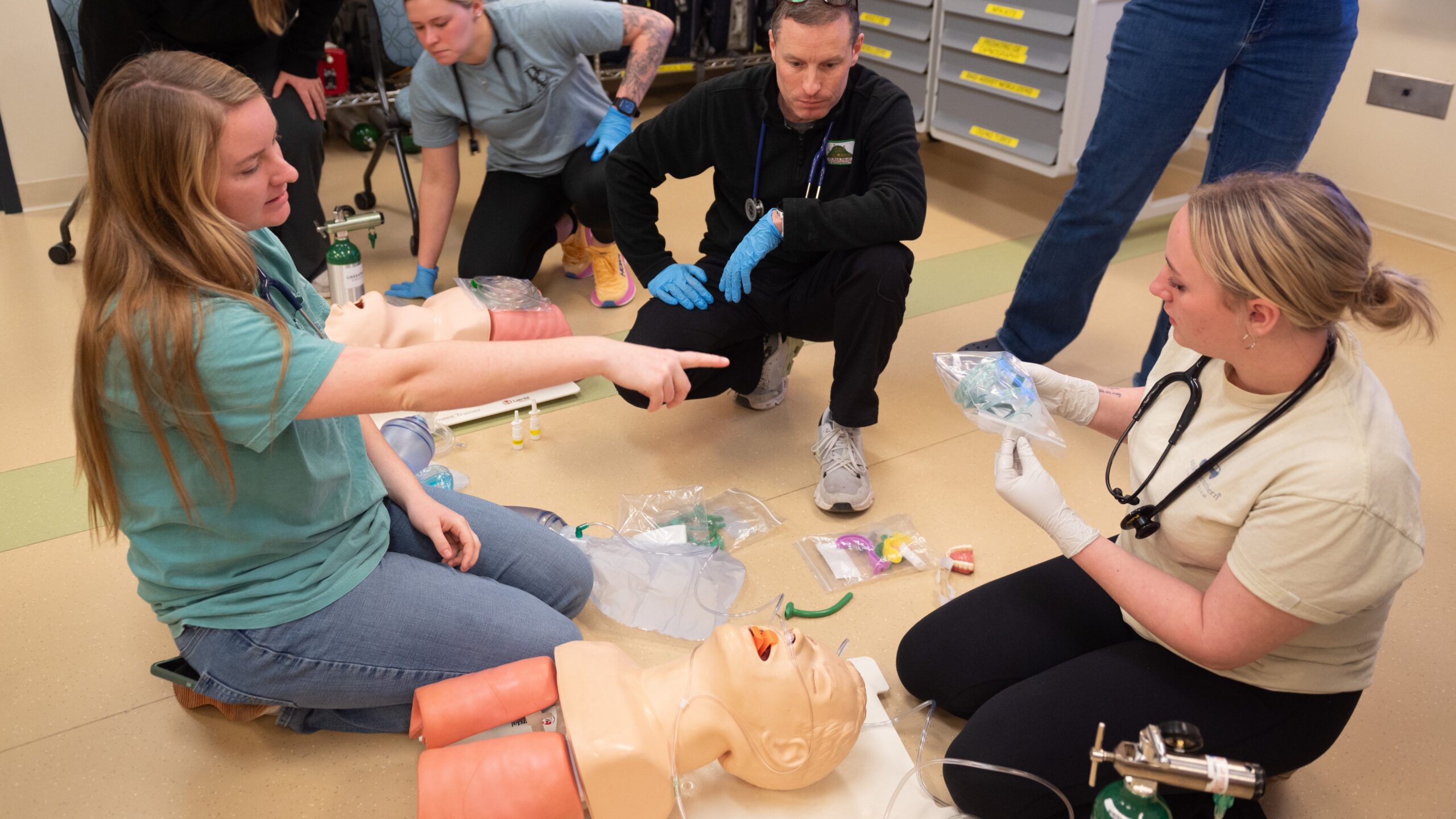 an example of EMT classes practicing their skills for promoting a Healthcare Open House for prospective students