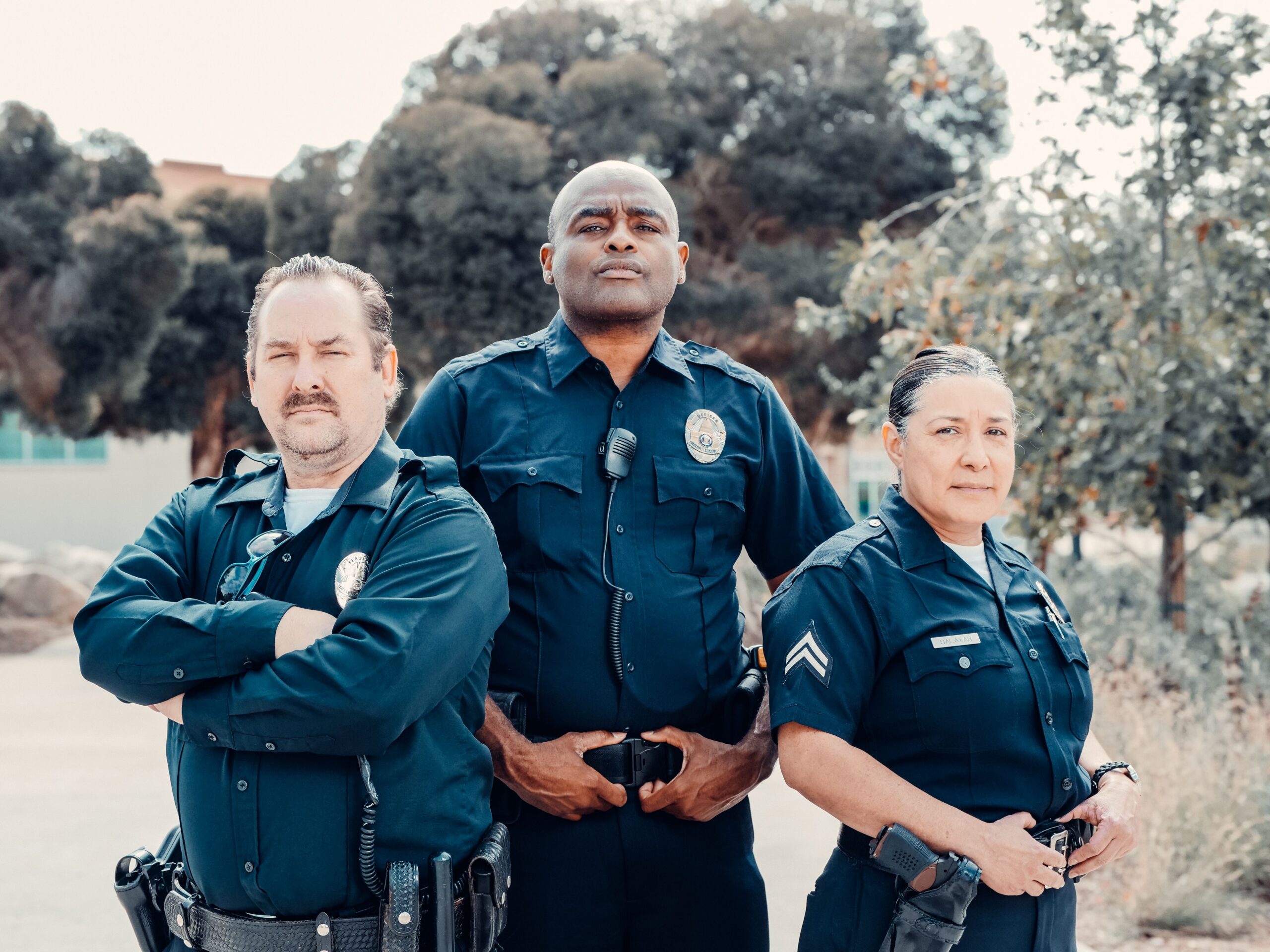 three men and woman in navy uniforms with badges illustrate the types of careers focused on during the criminal justice fair